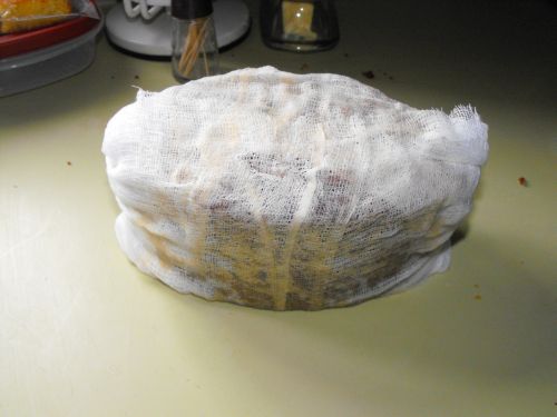 Finally, wrapped in cheesecloth. In years past I would then drench the cheesecloth with brandy. A couple years ago I realized it was a lot easier to soak the cheesecloth FIRST, then wrap it. It will be re-soaked twice before mailing.