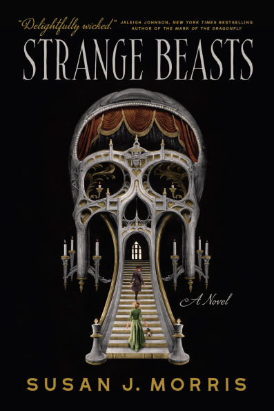 Cover of novel involving a skull shaped structure with a grand stair case leading to the mouth, with curtains and candles all aroun.
